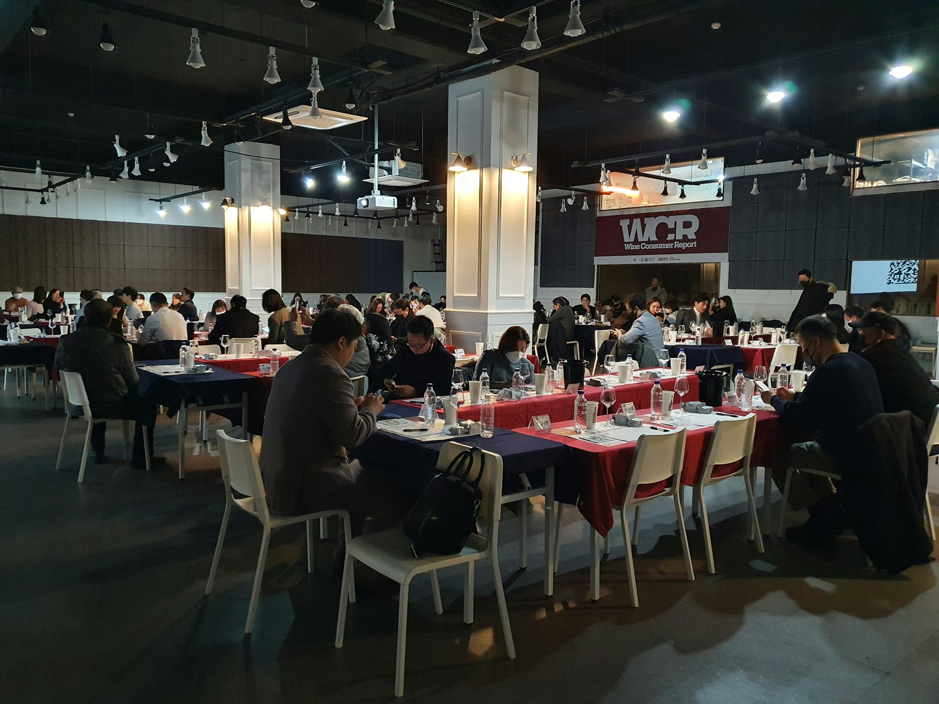 a group of people sitting at tables in a room